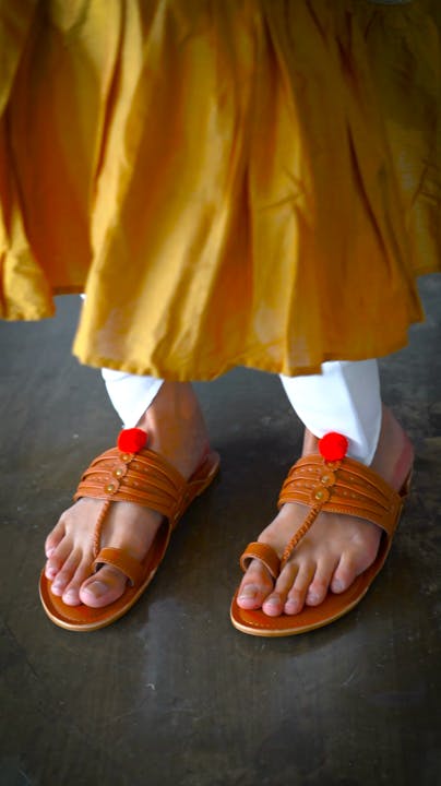 Orange,Yellow,Red,Barefoot,People in nature,Foot,Toe,Nail,Human leg,Street fashion